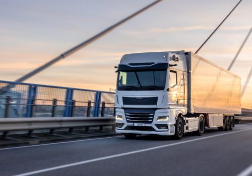 white-truck-crossing-bridge-sunset-urban-logistics-motion_169016-69995